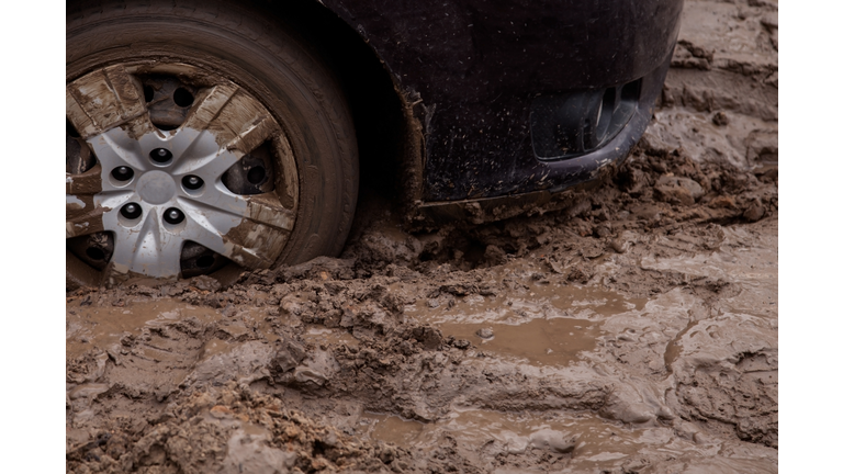 the car is stuck on a bad road in the mud