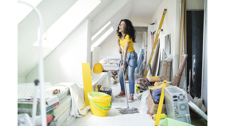 Woman cleaning up after home repair