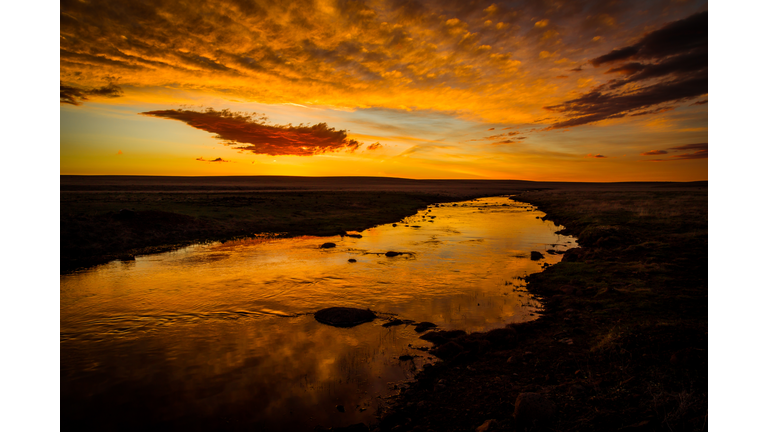 Golden Sunset reflection creek water clouds pink blue flat pasture