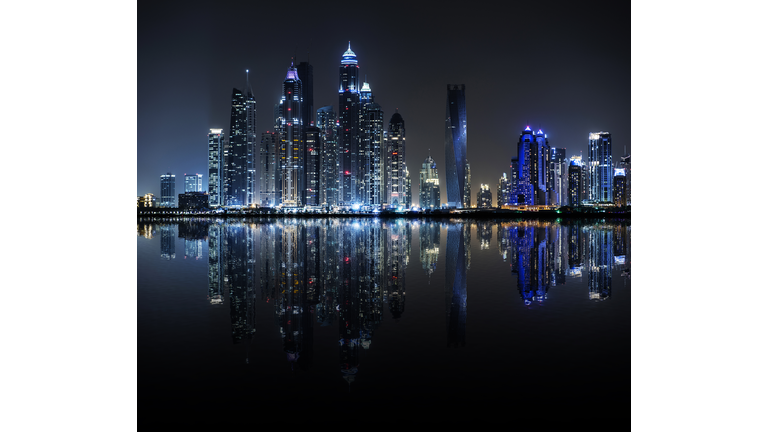 Night view of Dubai Marina reflected in water, Dubai, United Arab Emirates