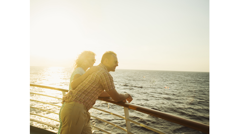 Caucasian couple admiring view from boat deck