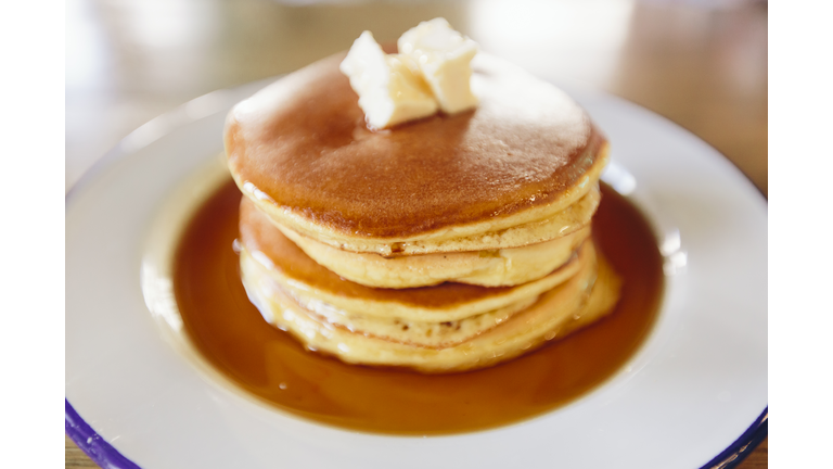 Close up of stack of American pancakes with butter and maple syrup