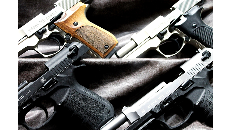 Close-Up Of Handguns On Fabric