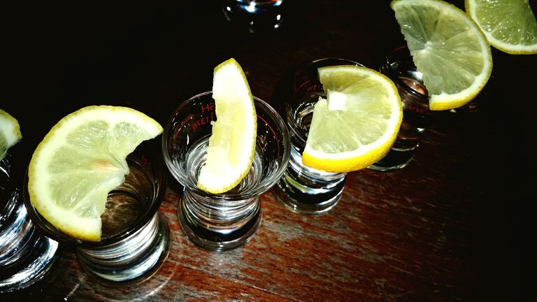 High Angle View Of Lemon Slices On Tequila Glasses At Restaurant