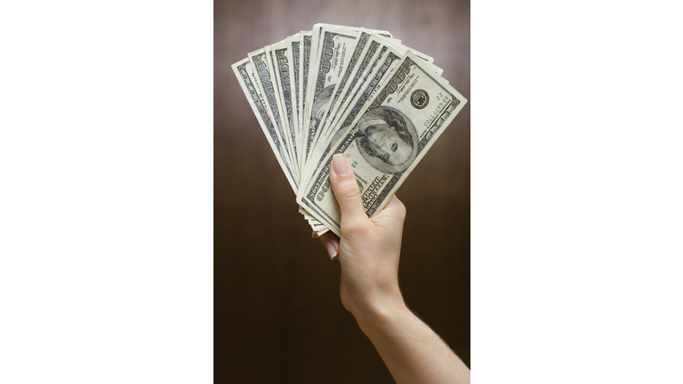 Woman holding fanned out money