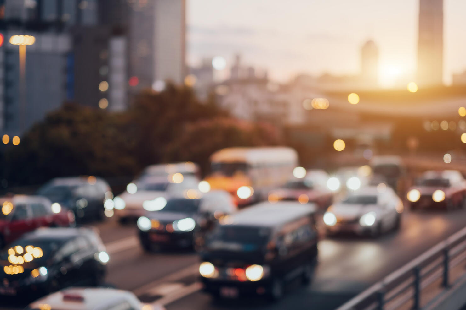 Blurry image of rush hour traffic on busy highway at sunset