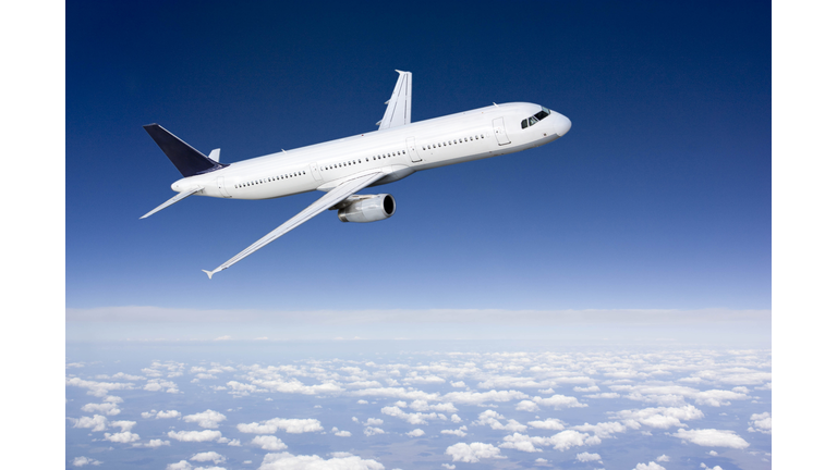 Passenger airplane flying above clouds