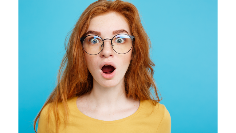 Portrait Of Shocked Woman Against Blue Background