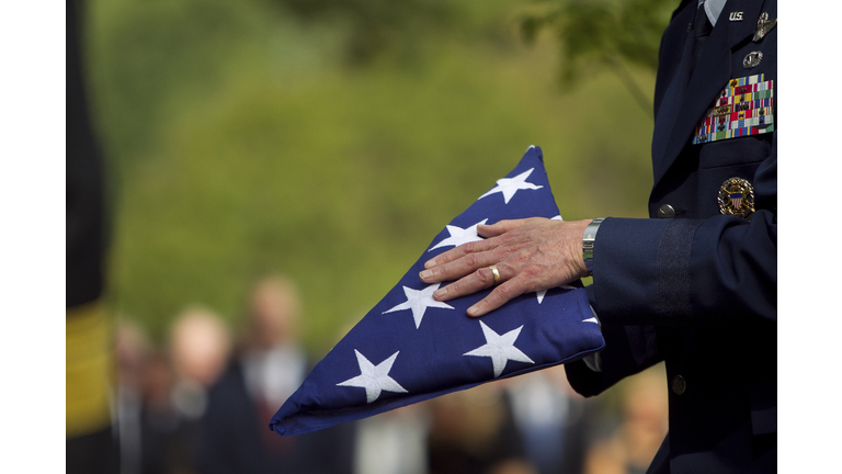 Soldier folding flag at military funeral