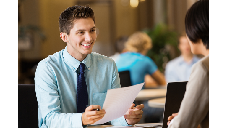 Young professional college student with resume at job interview