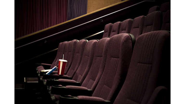 Lone drink + candy in empty theater.