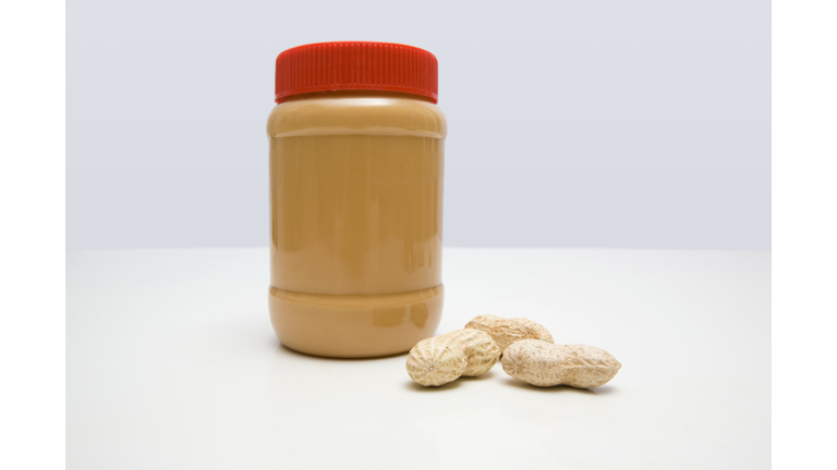 Jar of peanut butter and peanuts