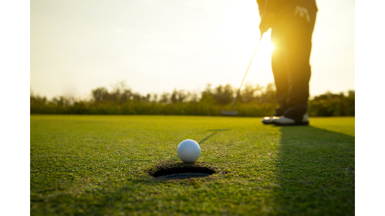 Low Section Of Man Standing On Golf Course