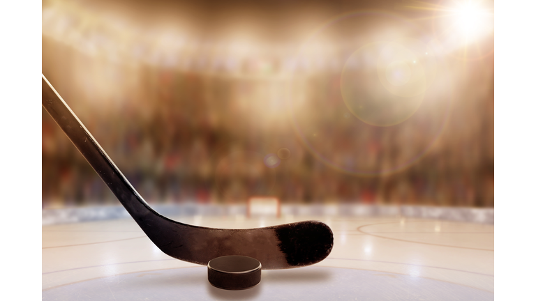 Ice Hockey Stick and Puck in Rink With Copy Space