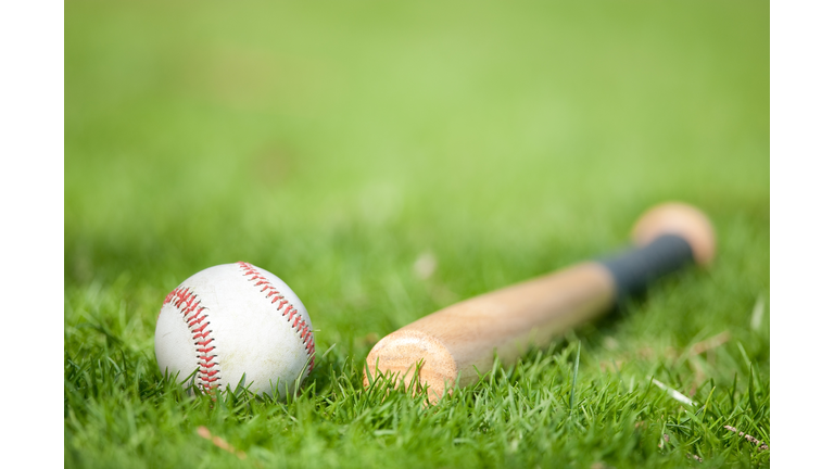 Close-Up Of Baseball Equipment On Grassy Field