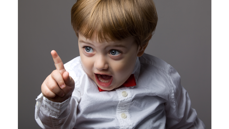 Little Boy With Blonde Hair Shaking His Finger For Warning