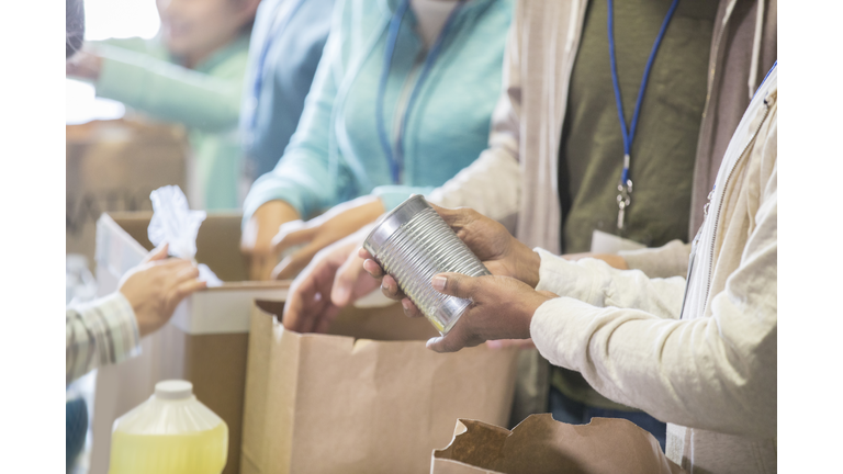 Unrecognizable people volunteering in food bank