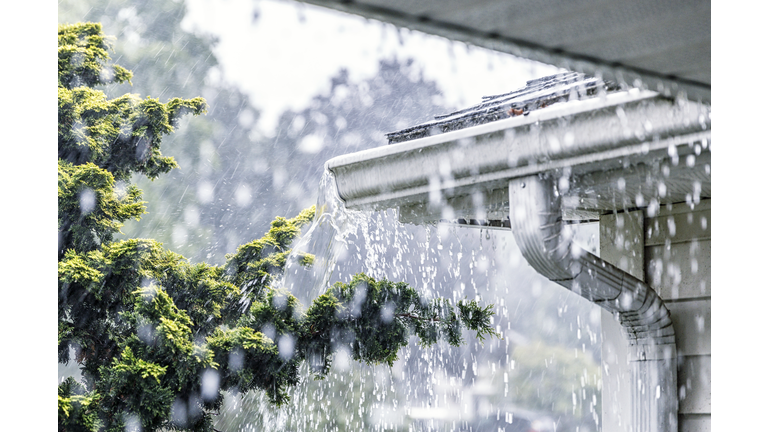 Torrential Summer Rain Storm Water Overflowing Roof Gutters