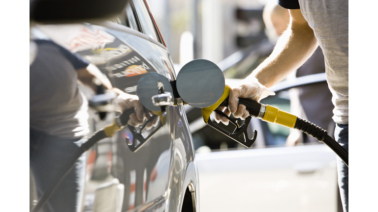 Refueling vehicle at gas station