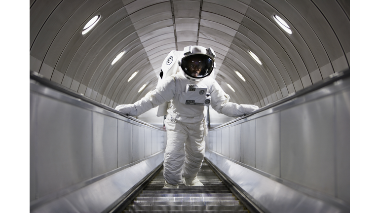 Astronaut using an escalator