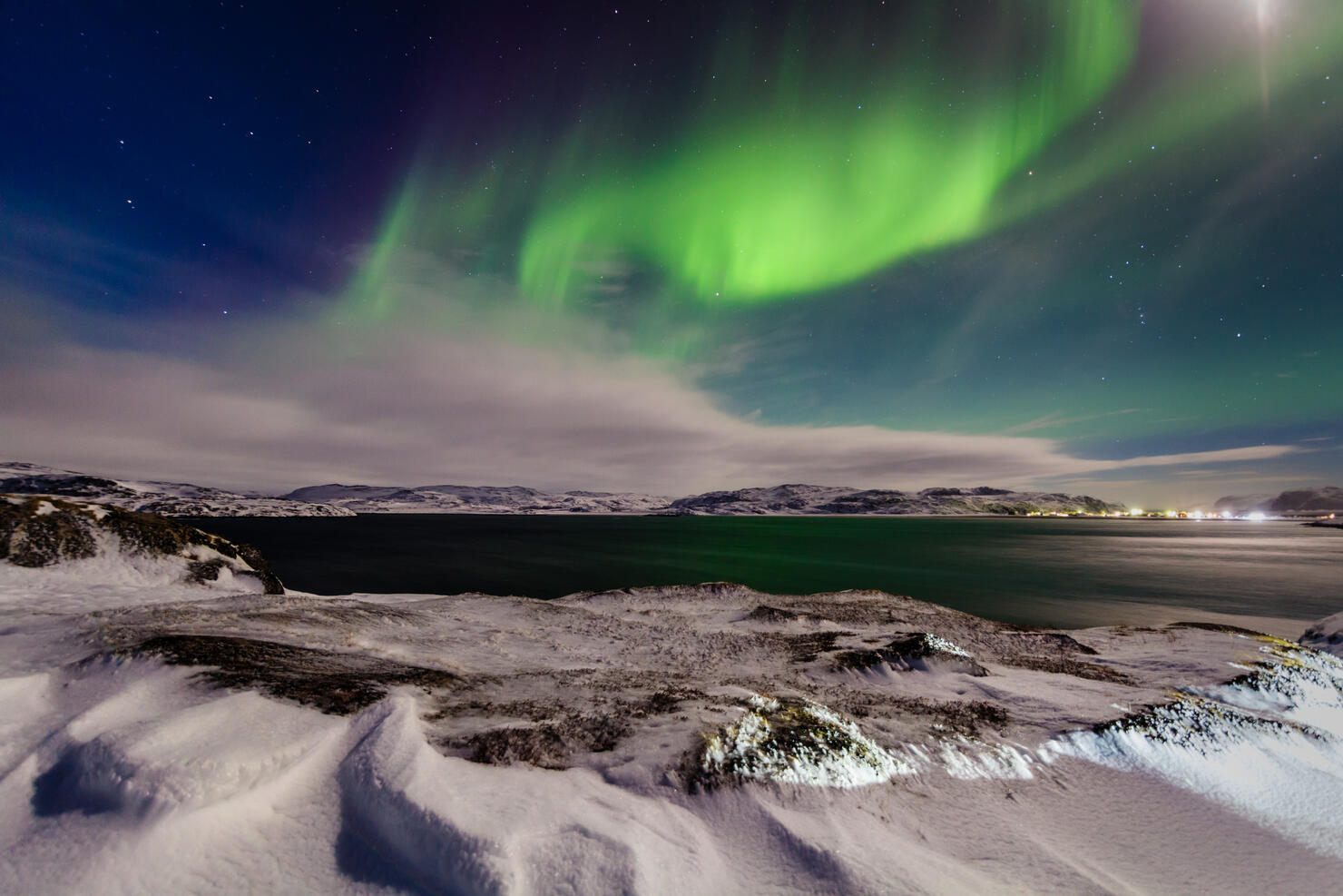 Northern lights in the snow-covered mountains