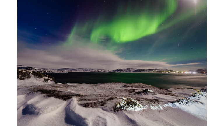 Northern lights in the snow-covered mountains