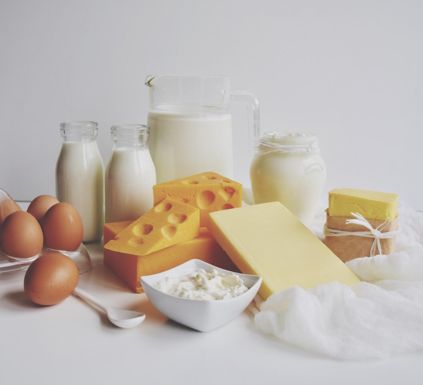 Close-Up Of Dairy Products On Table Against White Background