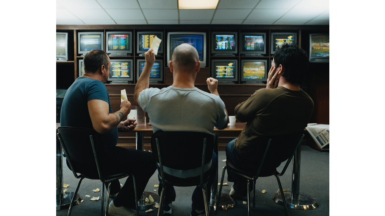 Three men in a betting shop