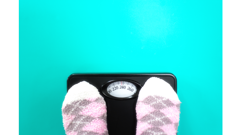 Overweight: Feet in Fuzzy Pink Socks on Scale
