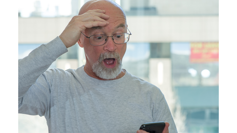 Bald Man with Phone - Perplexed