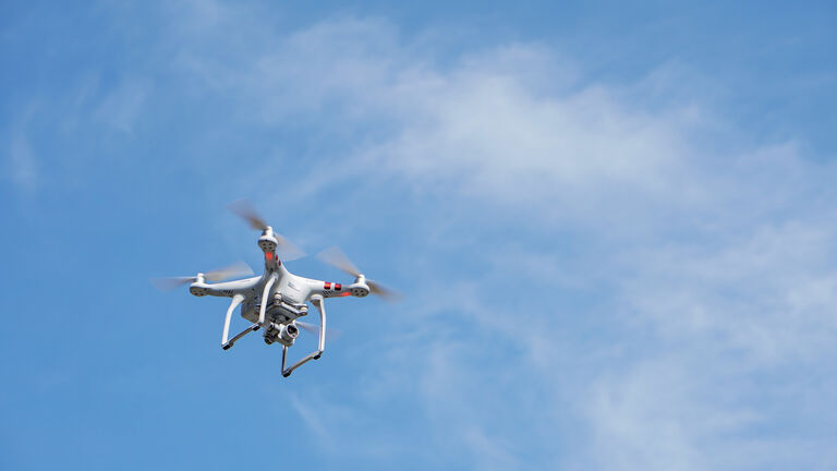 Low Angle View Of Drone Flying Against Sky