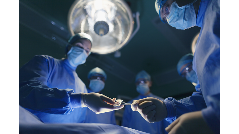 Operating room staff performing hospital surgery