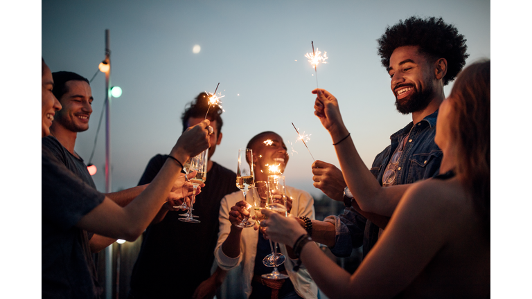 Friends celebrating at party on rooftop