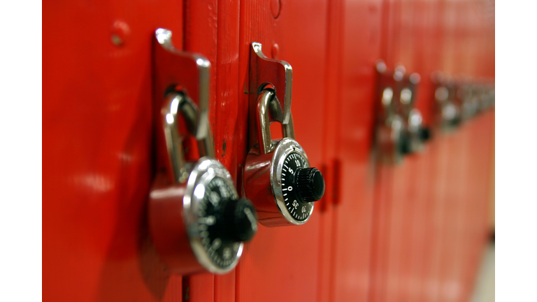 Combination locks on a row of red high school lockers