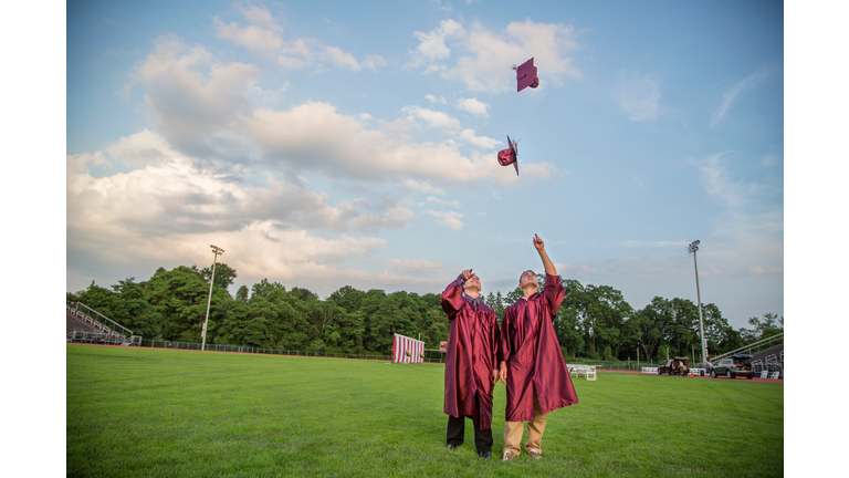 Graduates tossing up hats in mid air