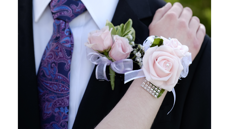 Hands of date Prom night flowers corsage formal wear