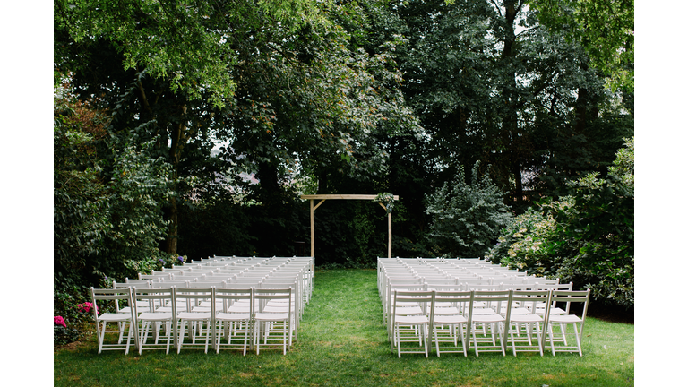 White chairs lined up for wedding ceremony