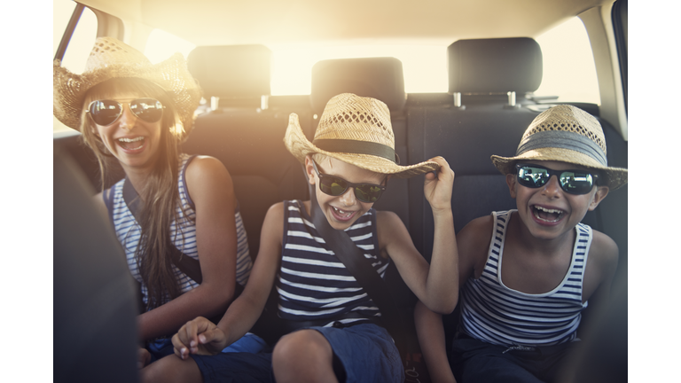 Kids enjoying road trip on sunny day