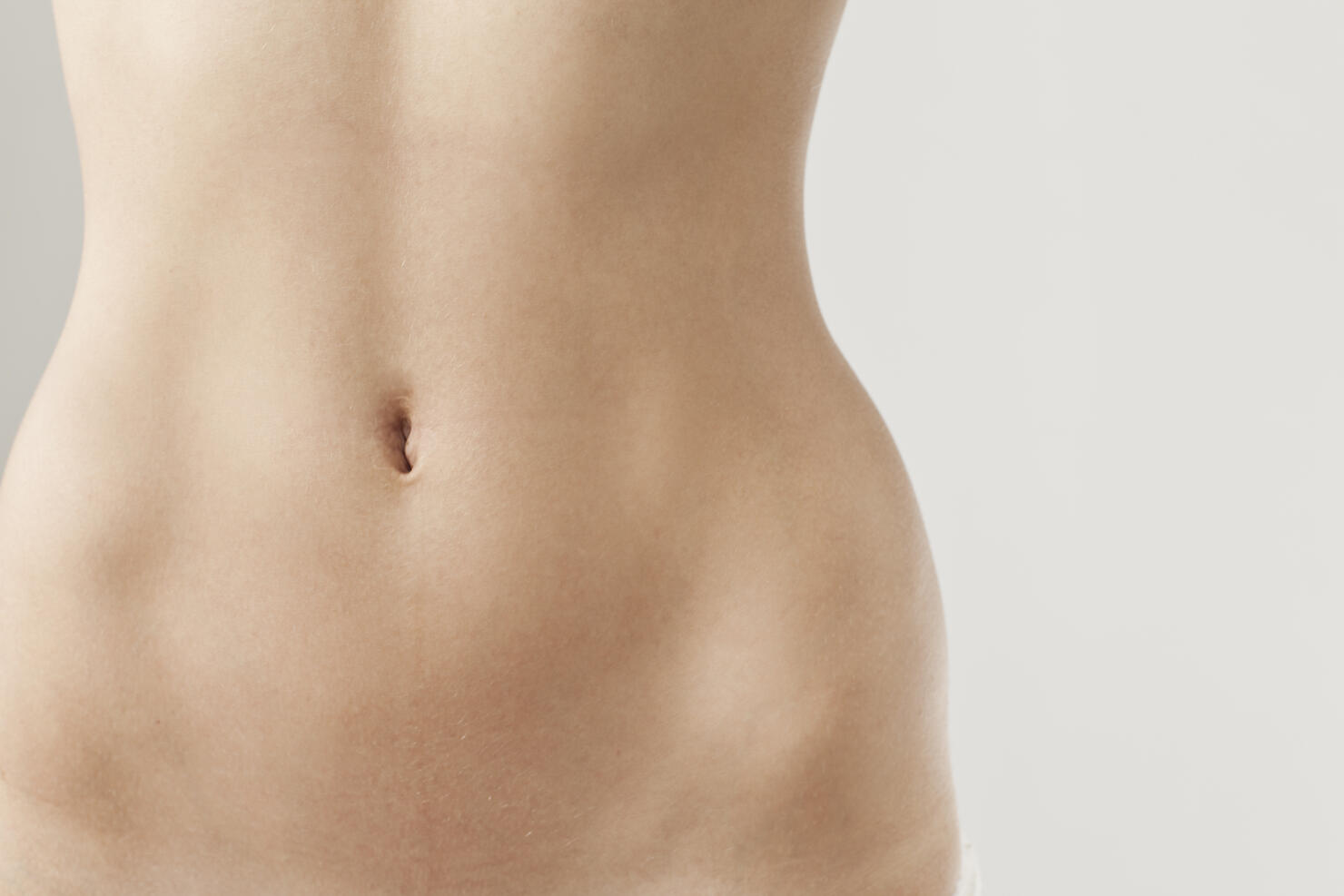 Detail view of womans naked belly