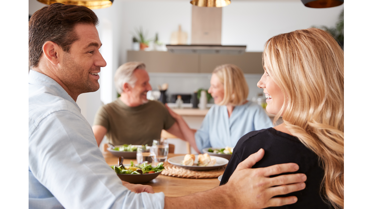 Introducing Boyfriend Or Girlfriend To Senior Parents At Meal Around Table At Home Together