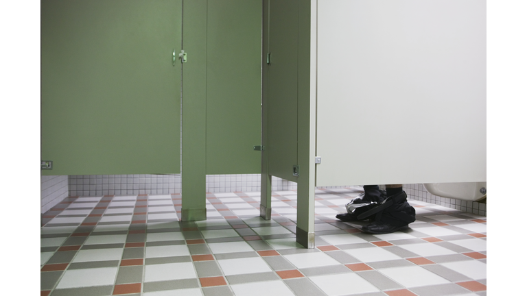 Businessman using public bathroom