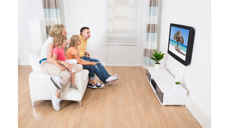 Young Family Watching TV Together