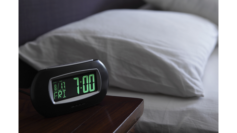 Alarm clock by bed