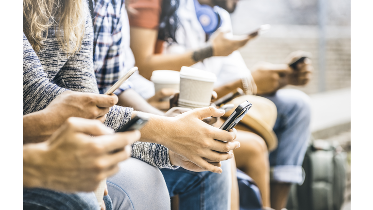 Multicultural friends group using smartphone with coffee at university college break - People hands addicted by mobile smart phone - Technology concept with connected trendy millennials - Filter image