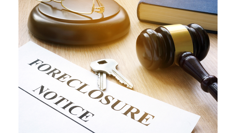 Foreclosure notice and keys on a court table.