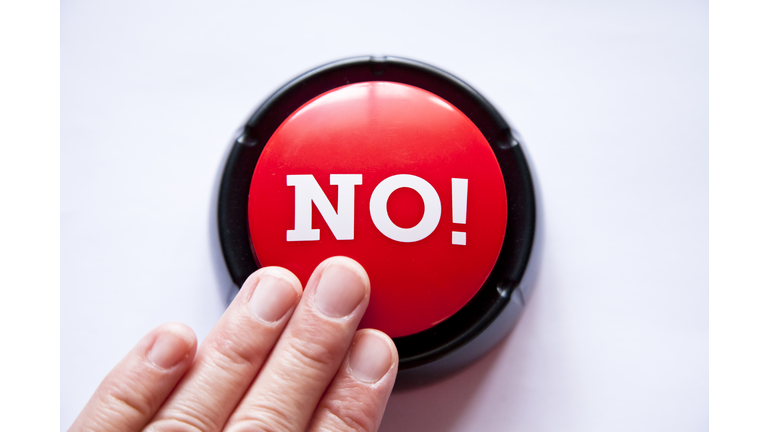 Woman pressing a button that says NO!