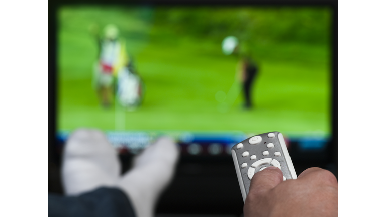 Hand holding a tv remote control