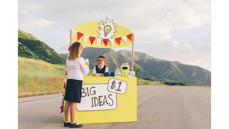 Young Business Boy Sells Big Ideas to Young Business Girl
