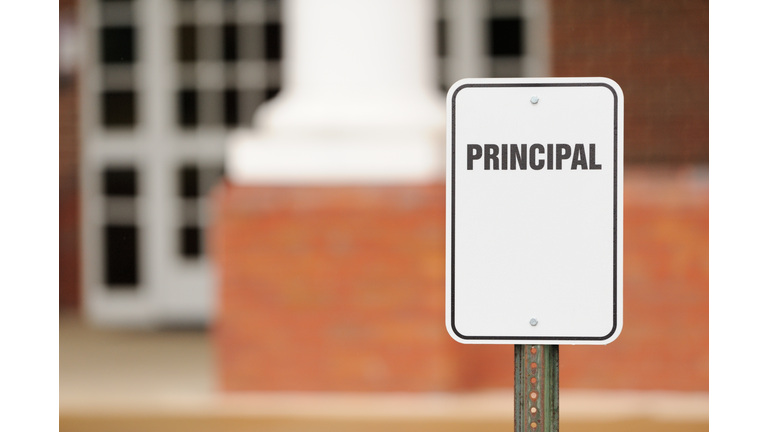 Principal sign for parking in front of school building