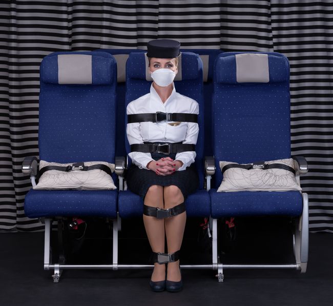 Air stewardess tied up with airline safety belts